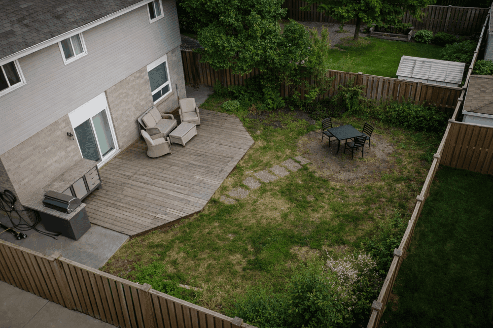 Completed outdoor dining and lounging zones with planting and pergola