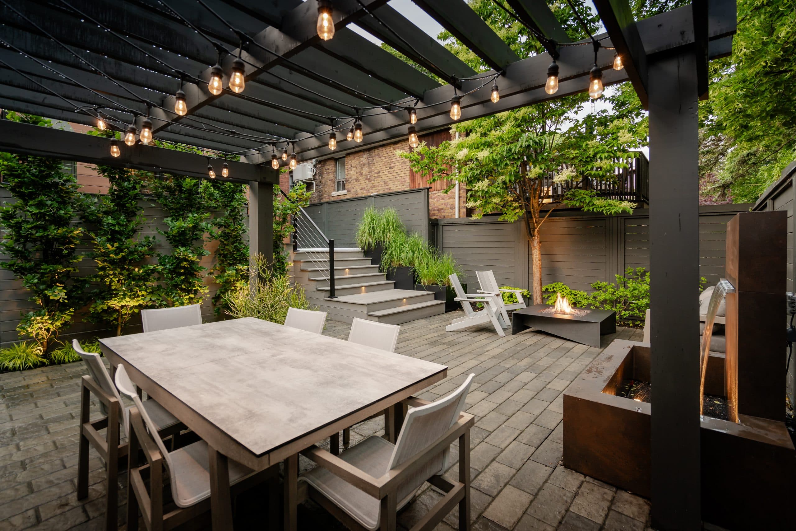 Lush landscaped garden with stone paths and mature plantings by Golden Mean Landscapes
